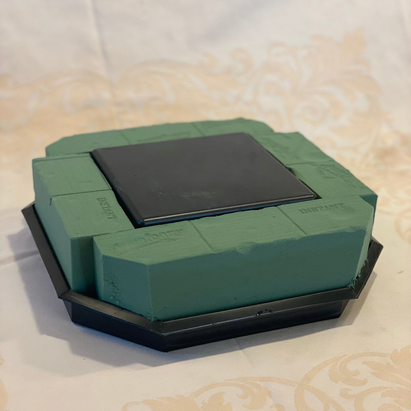 UrnTray with example of wet foam inserted to show what it should look like when it is ready to start designing flowers. for an urn wreath arrangement.